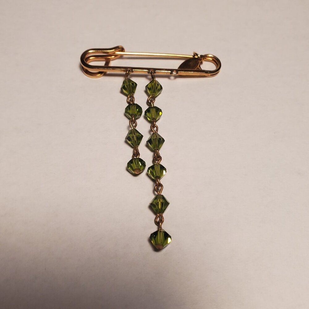 Tarina Tarantino gold safety pin brooch with green bead detail